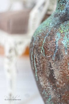 Close Up of Distressed Painted Bronze Painted on Vase
