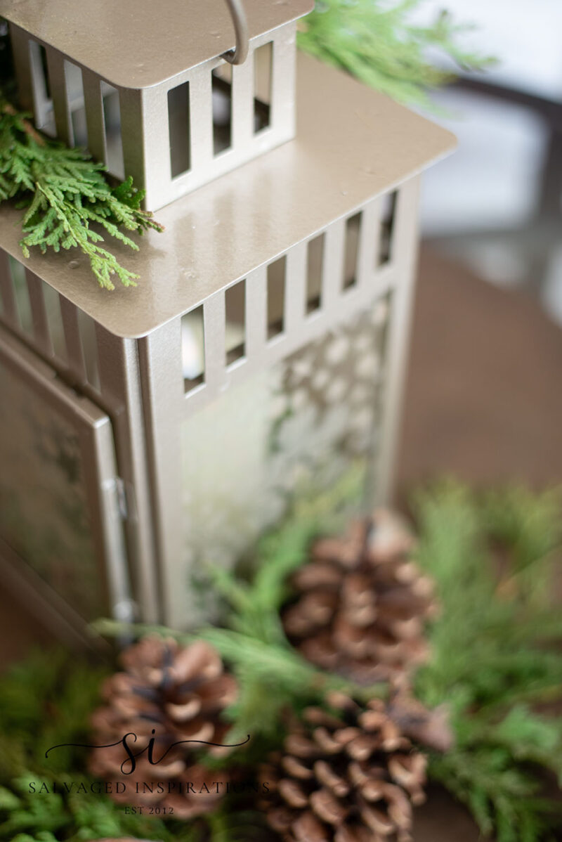 Pinecones and Greenery Around Christmas Candle